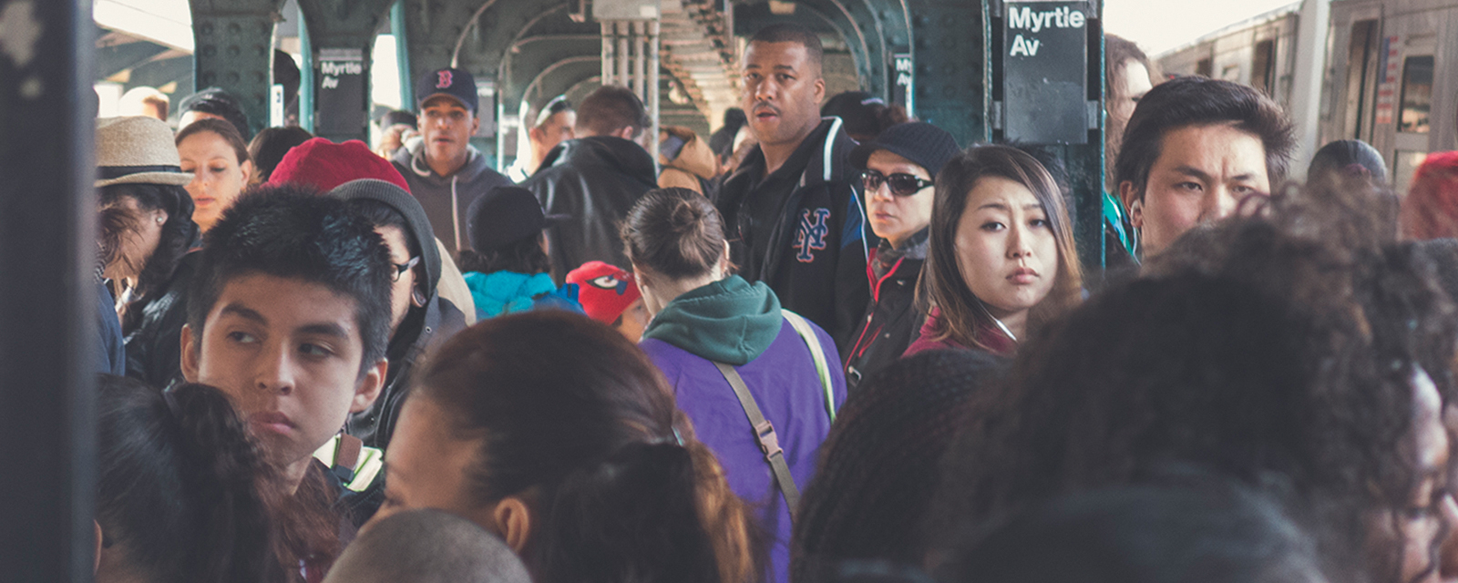 A crowd of people at a subway stop in New York