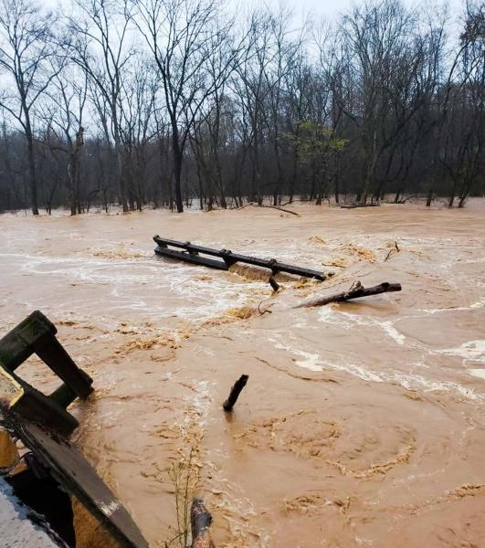 Bridge debris going downstream in muddy water