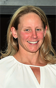 Headshot of a smiling woman with blond shoulder-length hair