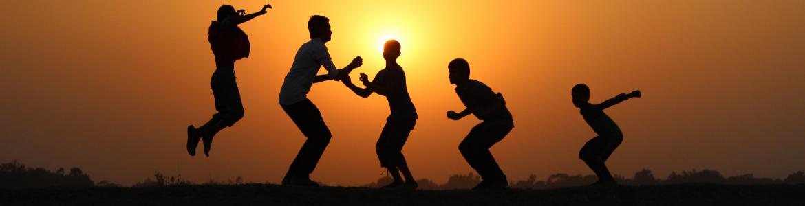 Children playing in the sunset